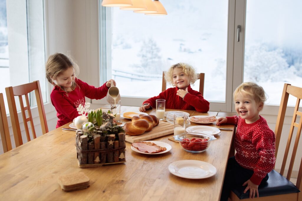 Kids enjoying Christmas morning breakfast in Christmas pajamas