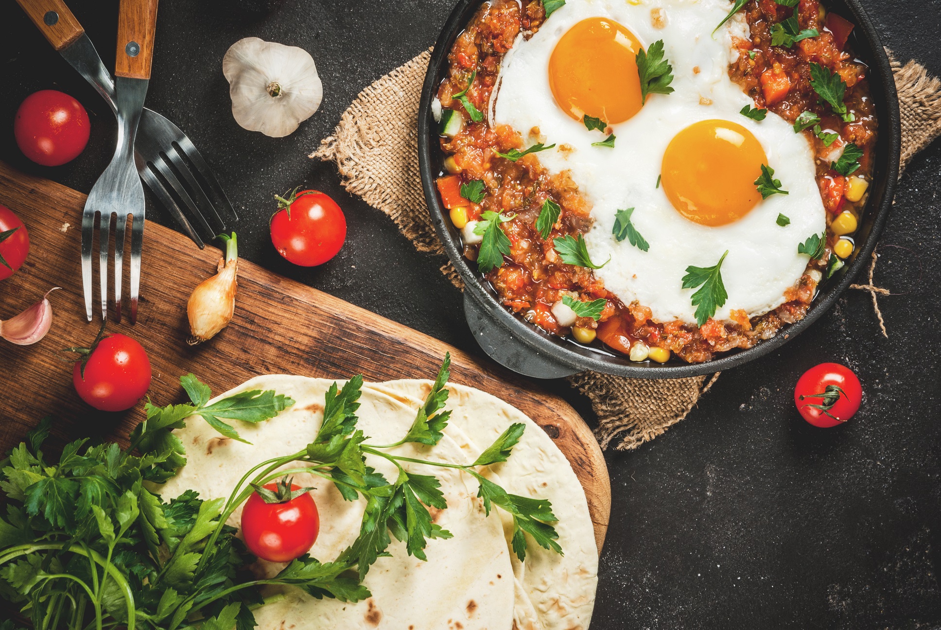 huevos rancheros and tortillas spread out on a table