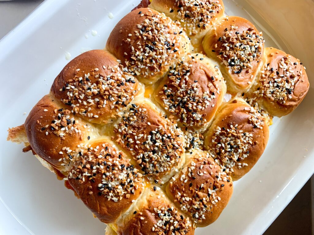 everything bagel sliders in baking dish